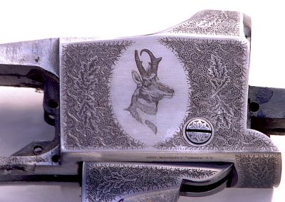 A Ruger No. 1 with antelope engraving surrounded by English style scroll with oak leaves.