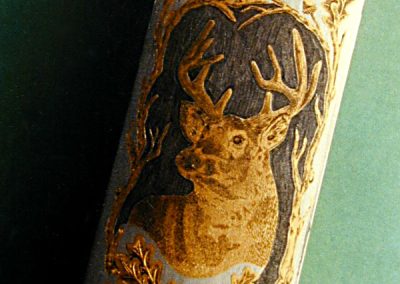 A multi-color engraving of a white-tailed deer adorns this part.