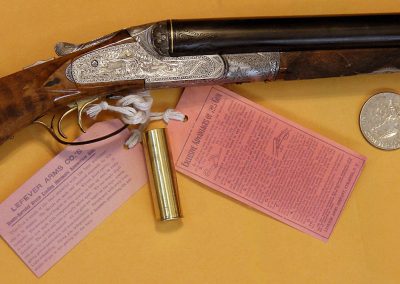 A close-up of the finished, engraved, and blued miniature shotgun.