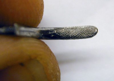 The trigger shows very fine checkering.