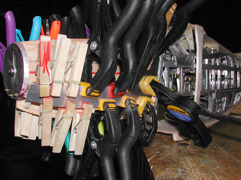Clamps Holding a Plate While the glue dries, many clamps hold a plate in place for riveting.