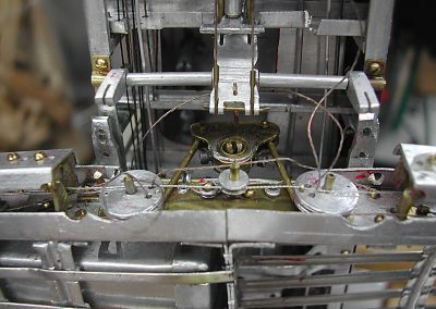 Control wires are threaded around their respective pulleys.