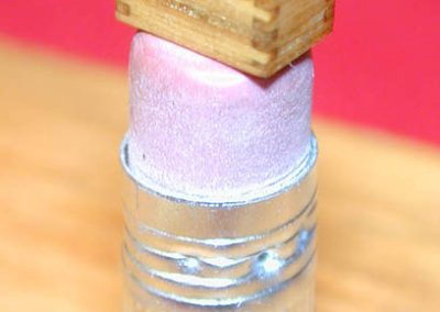 At shows, Jerry displays the tiny engine and its fitted box on top of a pencil eraser.