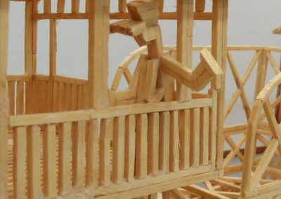 A matchstick engineer waves from the window of the cab.