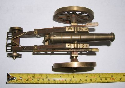 A tape measure shows the size of this 1/20 scale cannon.