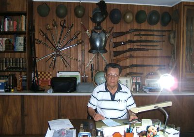 Guillermo Rivera stands behind his desk.
