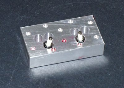 The top side of the head with spark plugs inserted.