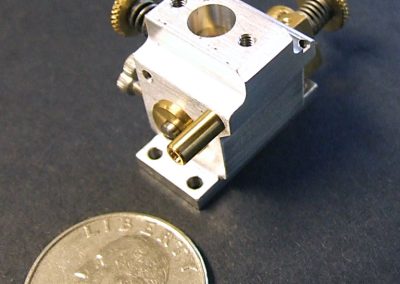The finished carburetor with a quarter for scale reference.