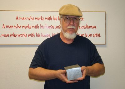 Tom holds the billet of aluminum that would become the engine block.