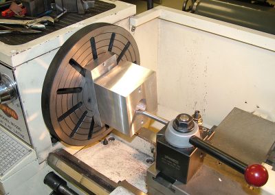 Boring the crankshaft hole in the aluminum block.