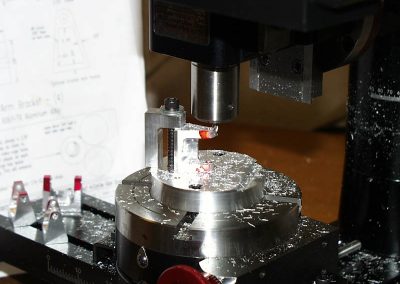 Machining the rocker arm brackets.