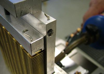 Tom placed small strips of solder on top of the fixture at two points on each side.