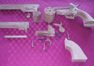 The disassembled Colt Pocket and Dragoon revolvers.