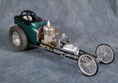 This front-engine altered dragster incorporates a model airplane engine for power.
