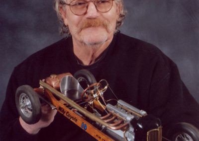 Will Neely holding one of his sale model race cars.
