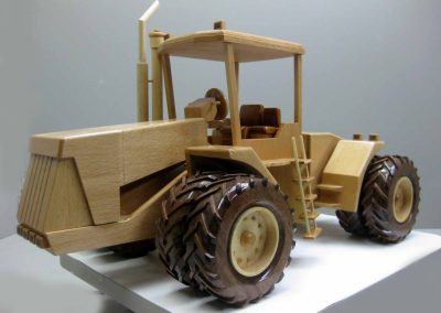 A wooden dual wheel tractor.