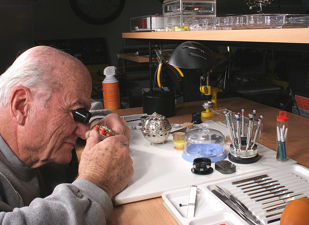 George Inspecting an Assembly George inspects a watch assembly on the bench.