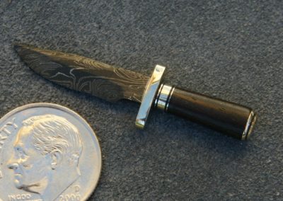 A custom miniature fixed blade knife made by Brian Jacobson.