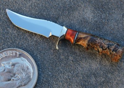 A custom miniature fixed blade knife made by Brian Jacobson.
