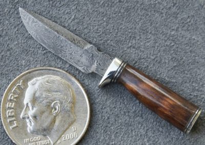 A custom miniature fixed blade knife made by Brian Jacobson.