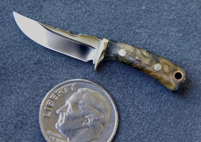 A custom miniature fixed blade knife made by Brian Jacobson.