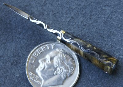A custom miniature fixed blade knife made by Brian Jacobson.