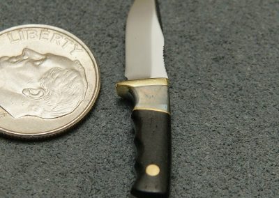 A custom miniature fixed blade knife made by Brian Jacobson.