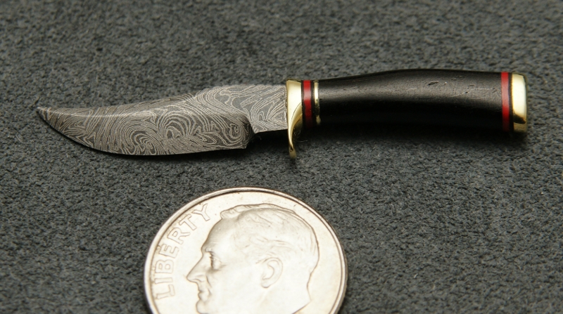 Miniature Fixed Blade Knife This miniature fixed blade knife features Damascus steel.