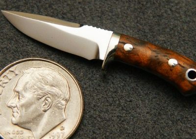 A custom miniature fixed blade knife made by Brian Jacobson.