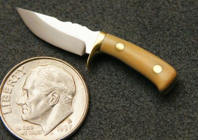 A custom miniature fixed blade knife made by Brian Jacobson.
