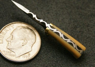 A custom miniature fixed blade knife made by Brian Jacobson.