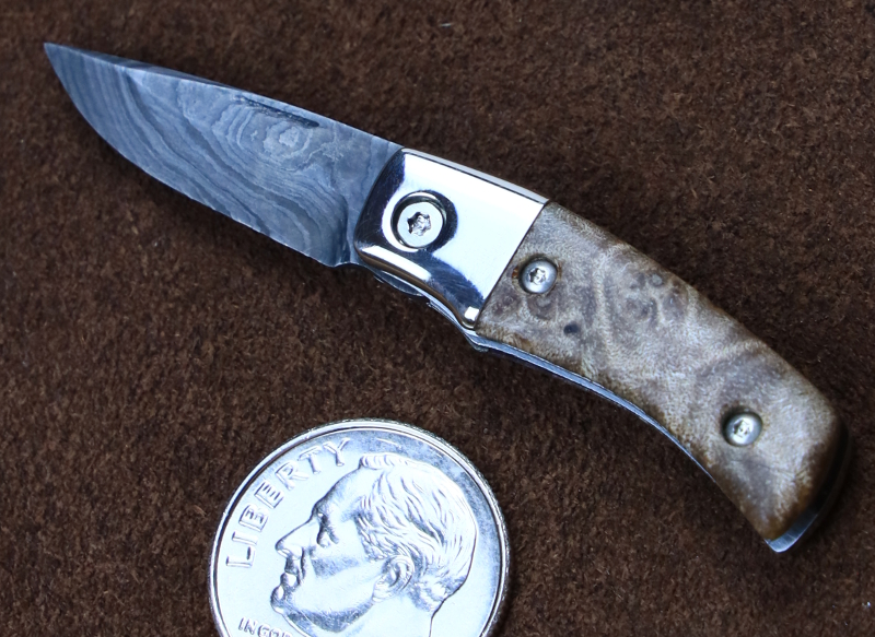 A custom miniature folding knife made by Brian Jacobson.