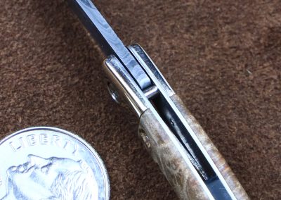 A custom miniature folding knife made by Brian Jacobson.