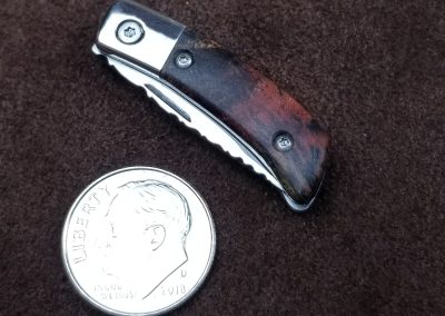 A custom miniature folding knife made by Brian Jacobson.
