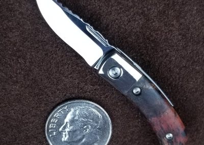 A custom miniature folding knife made by Brian Jacobson.