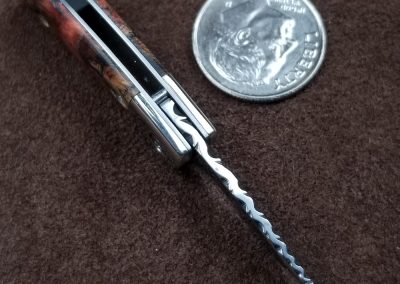 A custom miniature folding knife made by Brian Jacobson.