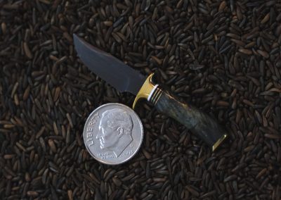 A custom miniature fixed blade knife made by Brian Jacobson.