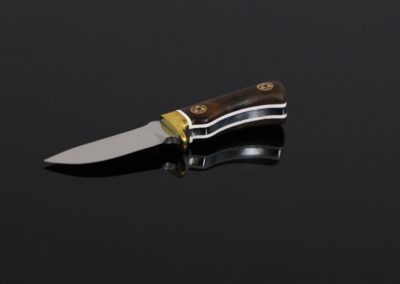 A custom miniature fixed blade knife made by Brian Jacobson.