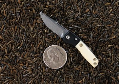 A custom miniature folding knife made by Brian Jacobson.