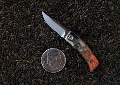 A custom miniature folding knife made by Brian Jacobson.