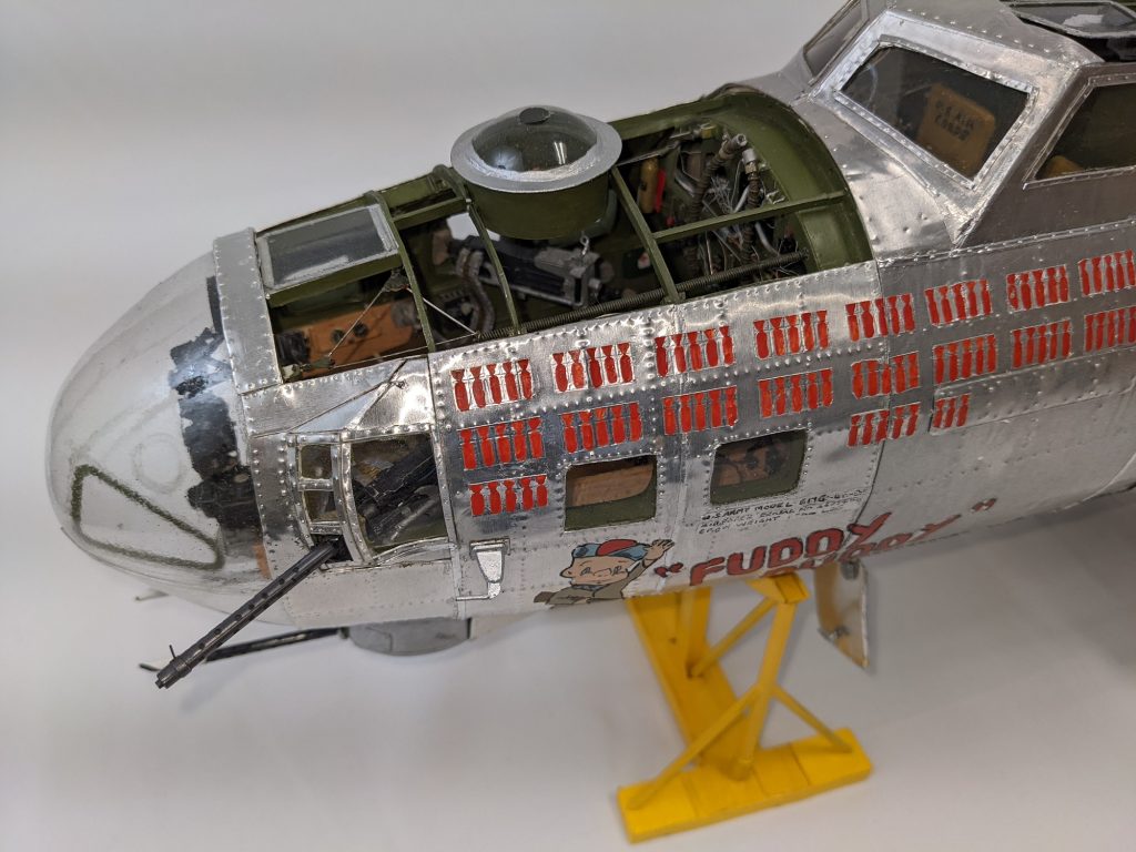 The 1/20 scale model airplane is complete down to the painted decals.