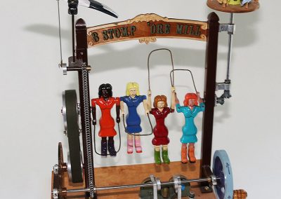 This piece is entitled, "8 Stomp 'Ore Mill," and it features four figures jumping rope.