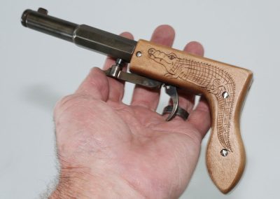 Birk’s small underhammer Gator Pistol features an alligator carved into the wooden handle.