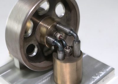 An elbow engine is a piston-based engine typically fed by steam or compressed air.