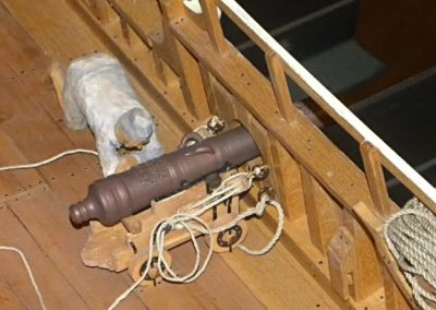 A close-up detail of one of Clayton's cannons on the upper deck.