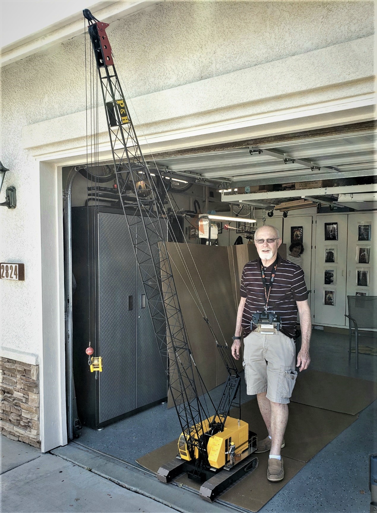 Thomas With His Model Crane Thomas Garing stands with his 1/12 scale model P&H 1015 crawler lattice boom crane.