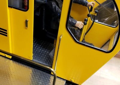 A small model figure serves as the crane operator.