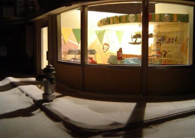 The Tip Top Toys store at night.