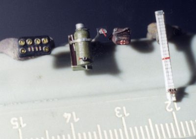 A miniature instrument panel, oxygen bottle, first aid kit, and mercury altimeter.