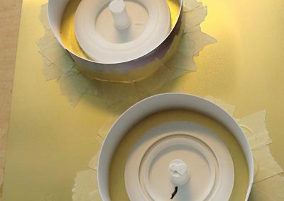 Temporary paper dams help contain the liquid molding material.